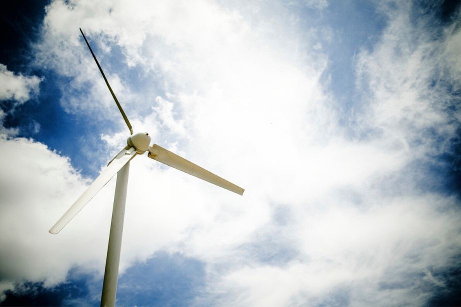 Wind turbine against blue sky and clouds