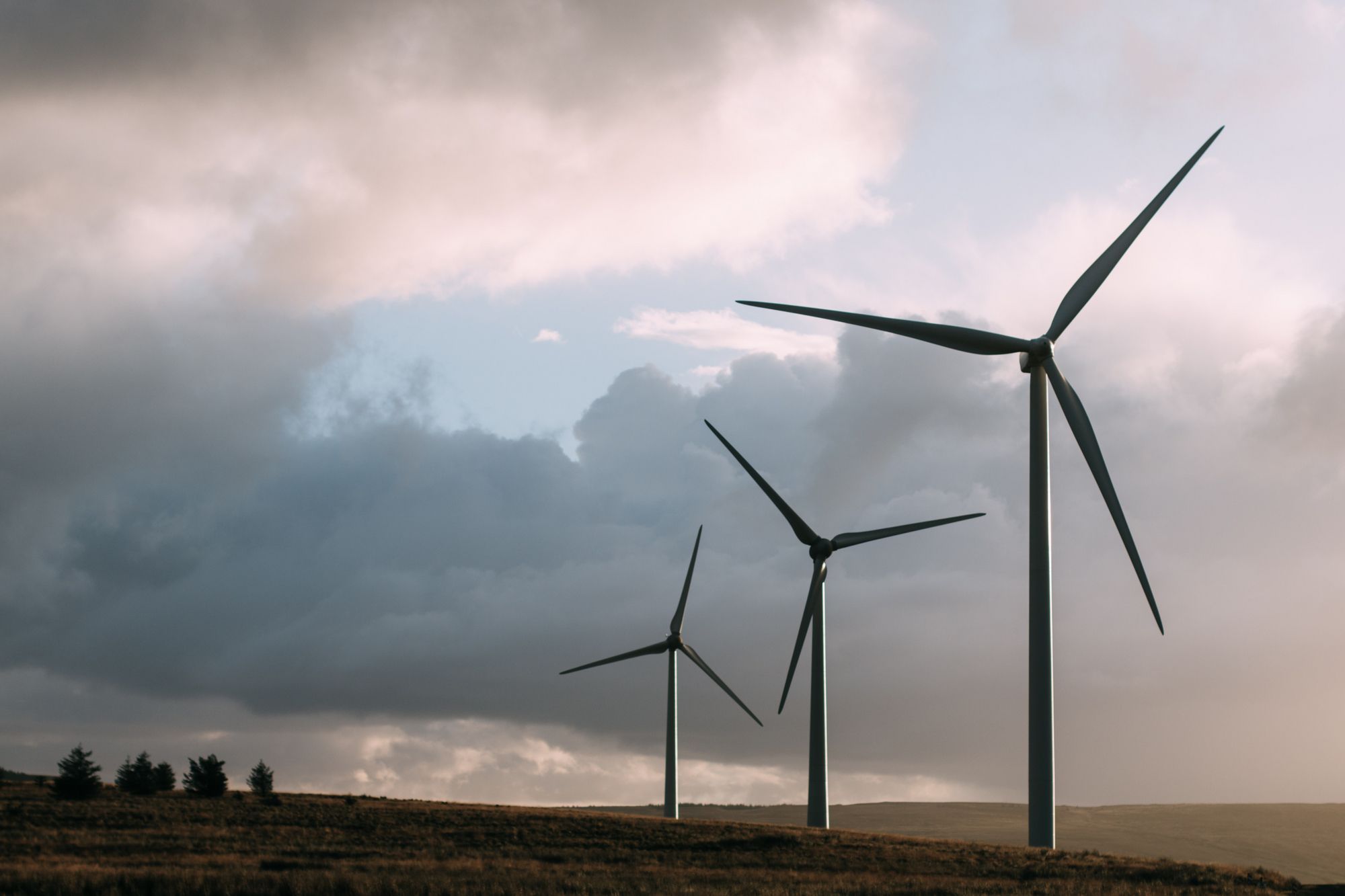 Wind turbines in front of moody sky