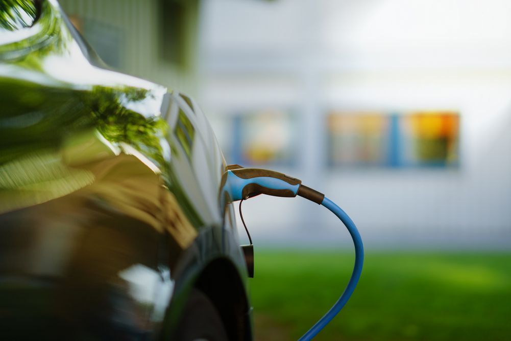 an EV charger plugged in to an electric car