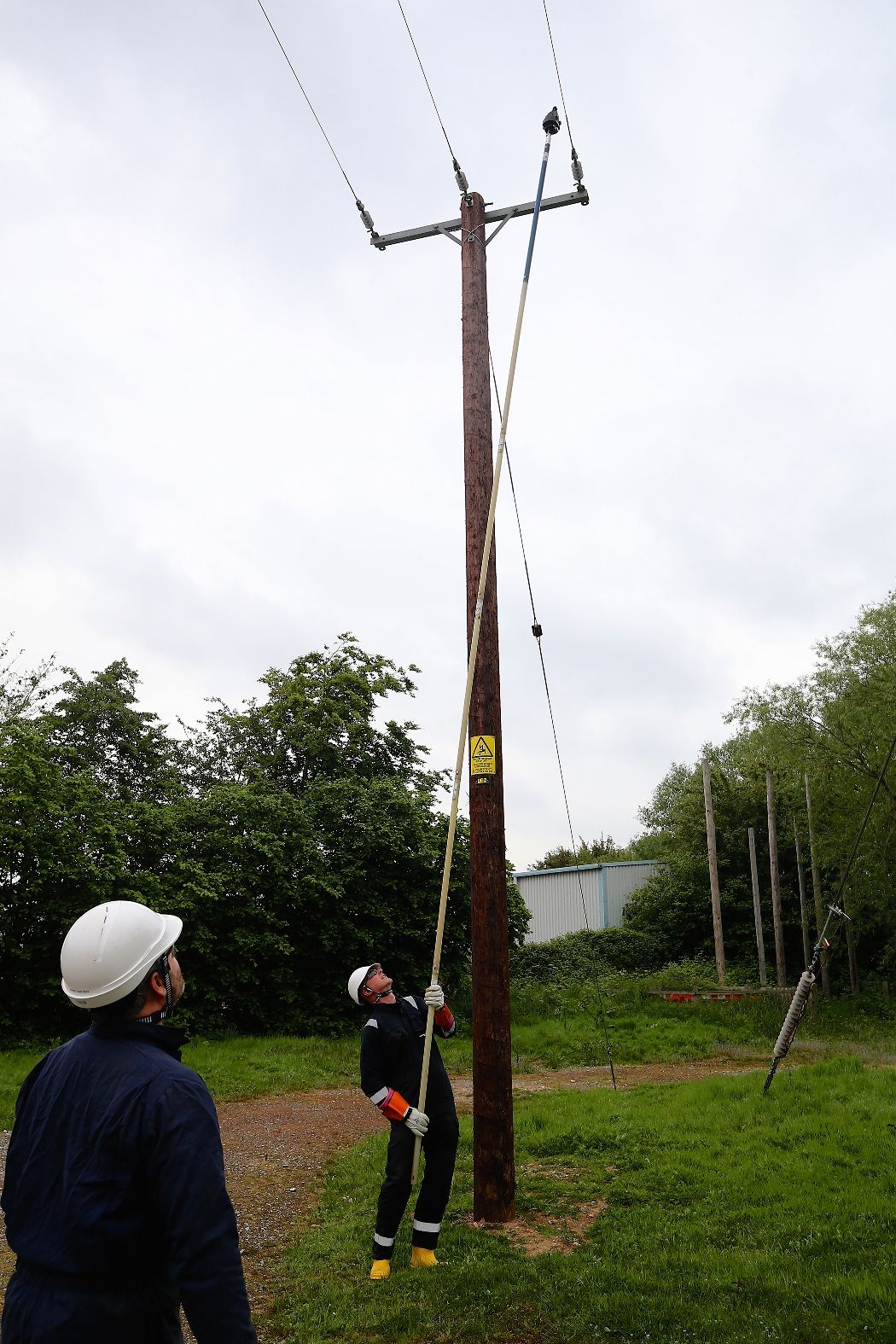 Engineer adding smart navigator to overhead electricity power lines