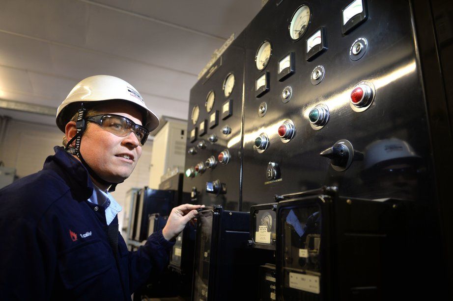 WPD engineer in hard hat working with a machine