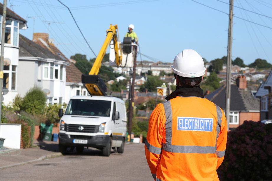 WPD staff replace overhead lines in a suburban street