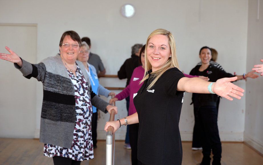 Older people dancing with instructor